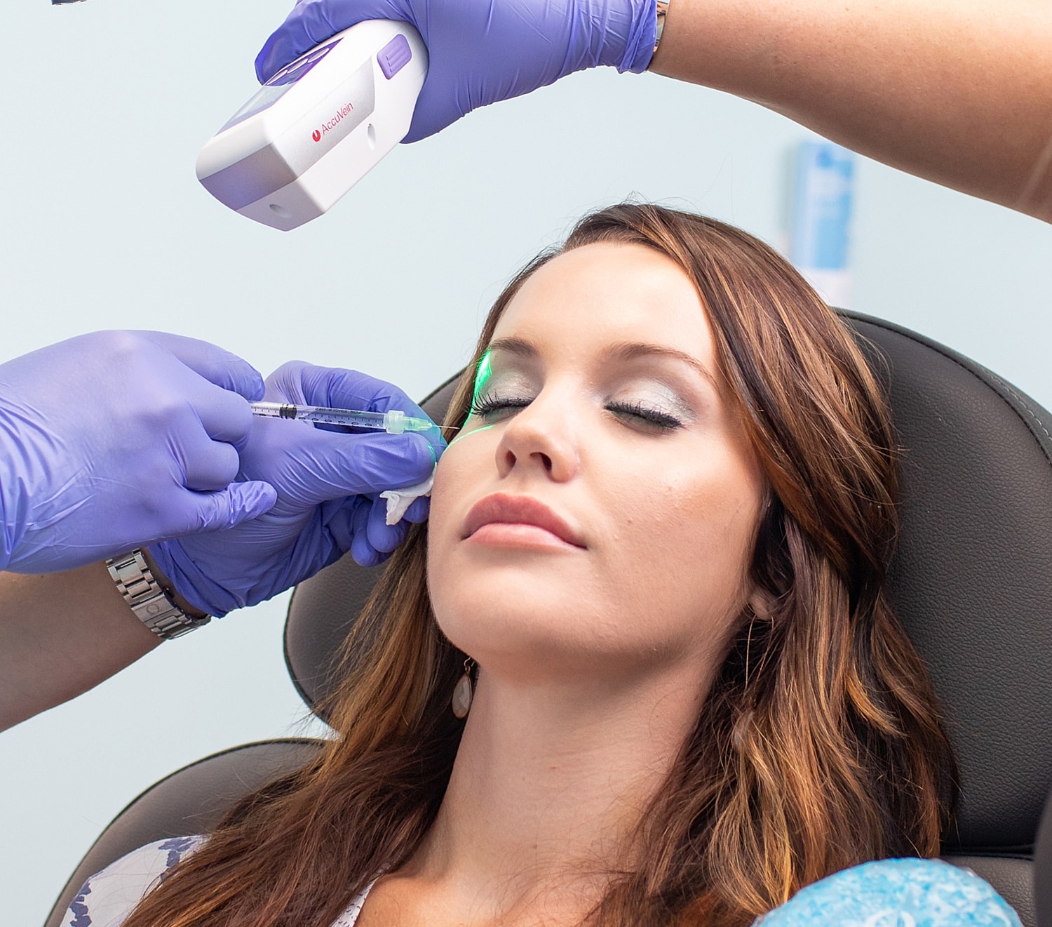 Laser treatment being administered on a woman's face.