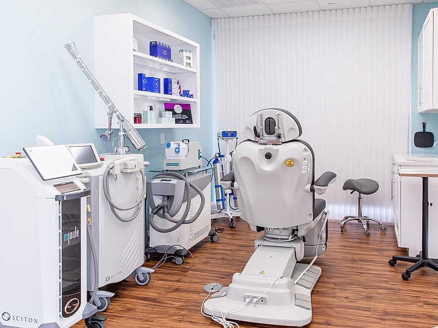 Medical treatment room with equipment and chair.