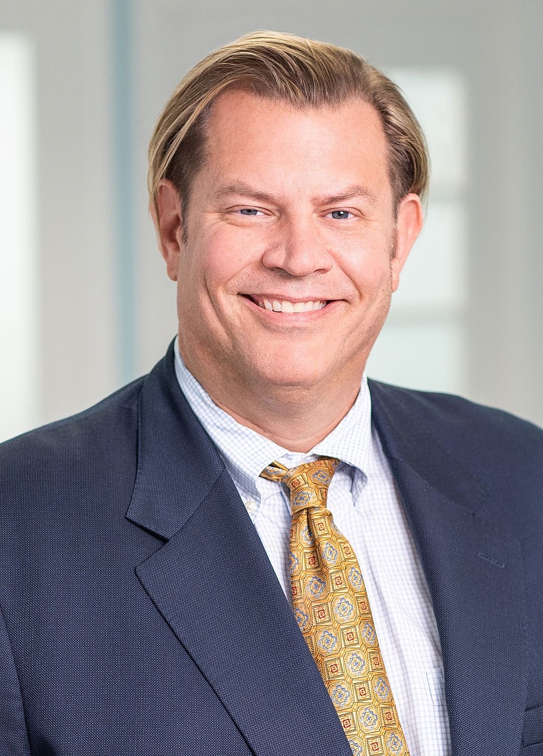Professional man smiling in business attire.