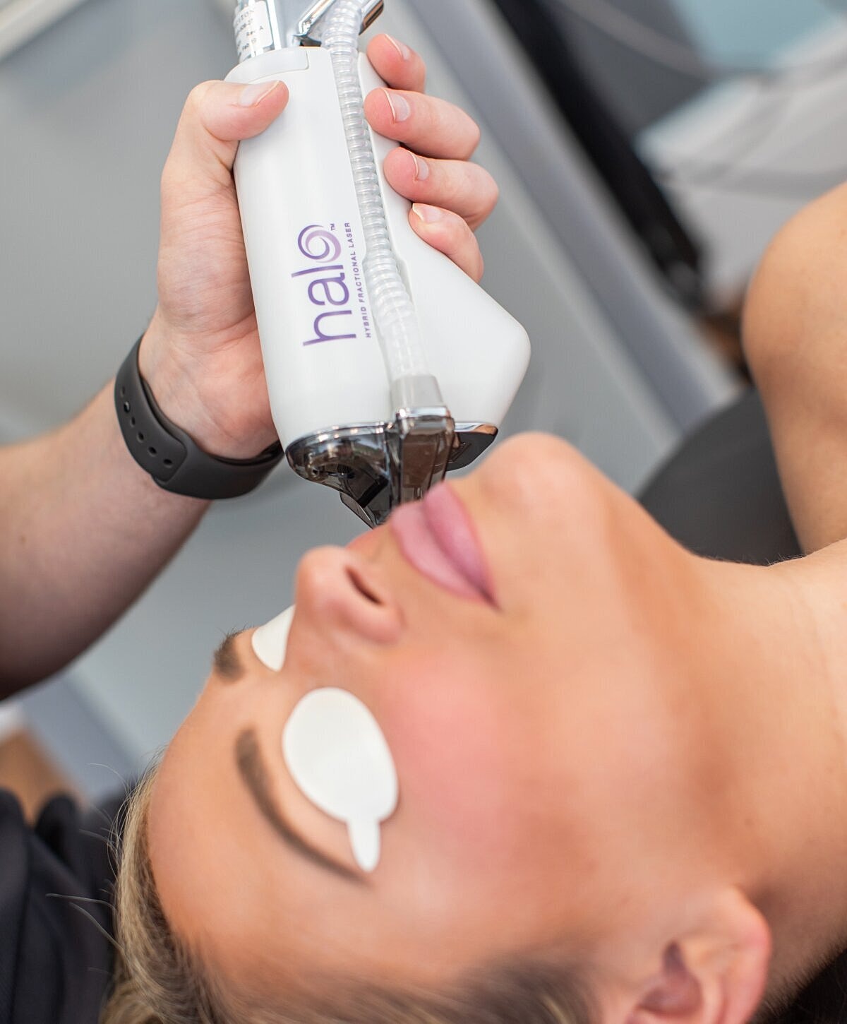 Woman with wavy hair and statement earrings.