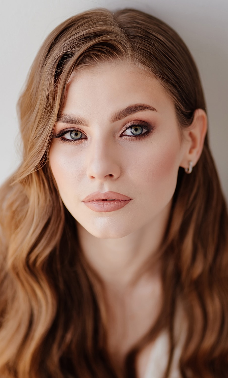 Portrait of a woman with long wavy hair.