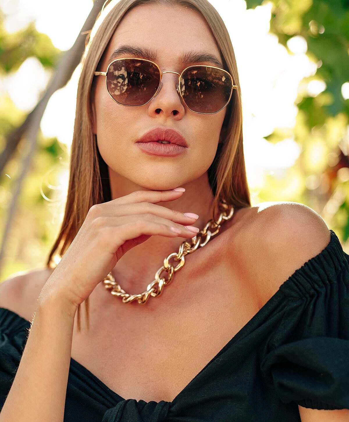 Woman with wavy hair and statement earrings.