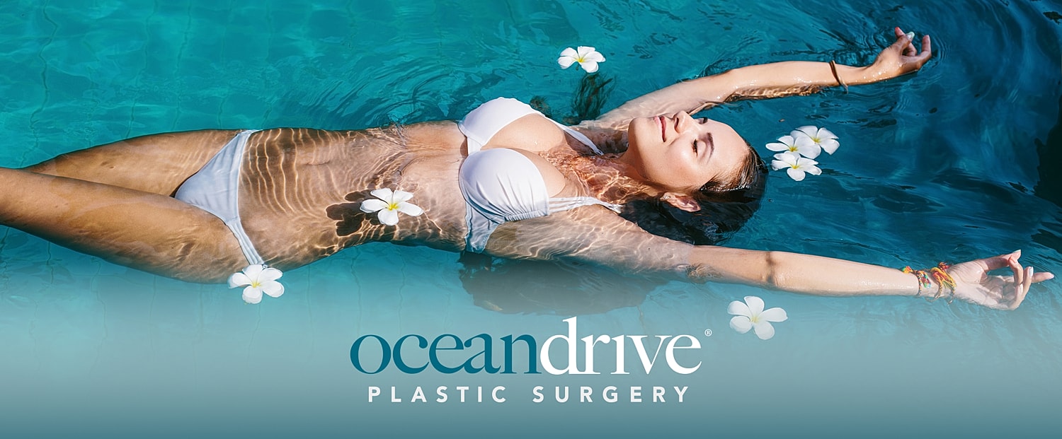 Woman floating in water surrounded by flowers.