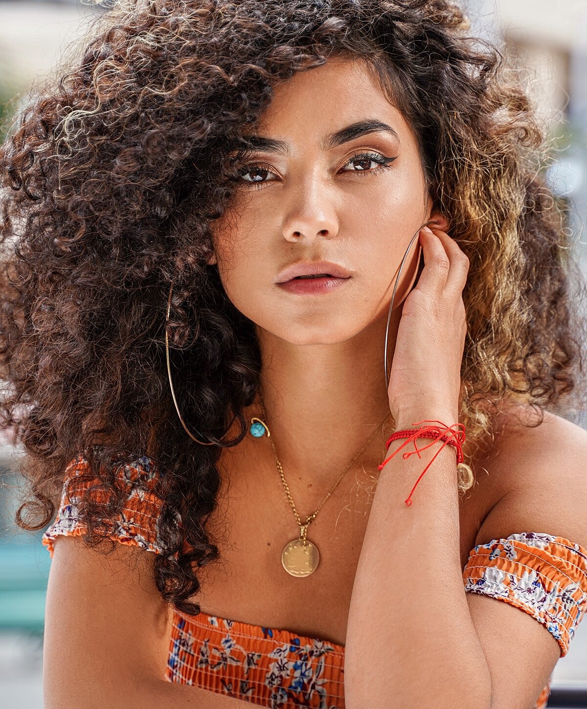 Portrait of a woman with long wavy hair.