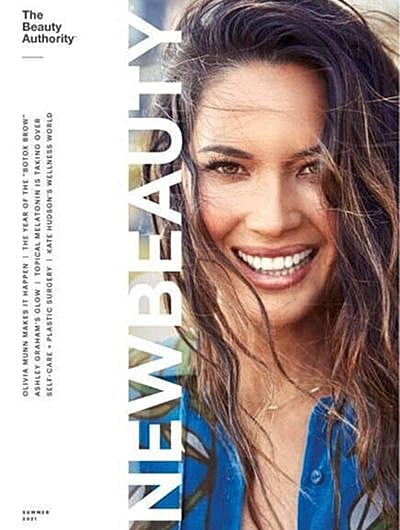 Smiling woman featured on beauty magazine cover.