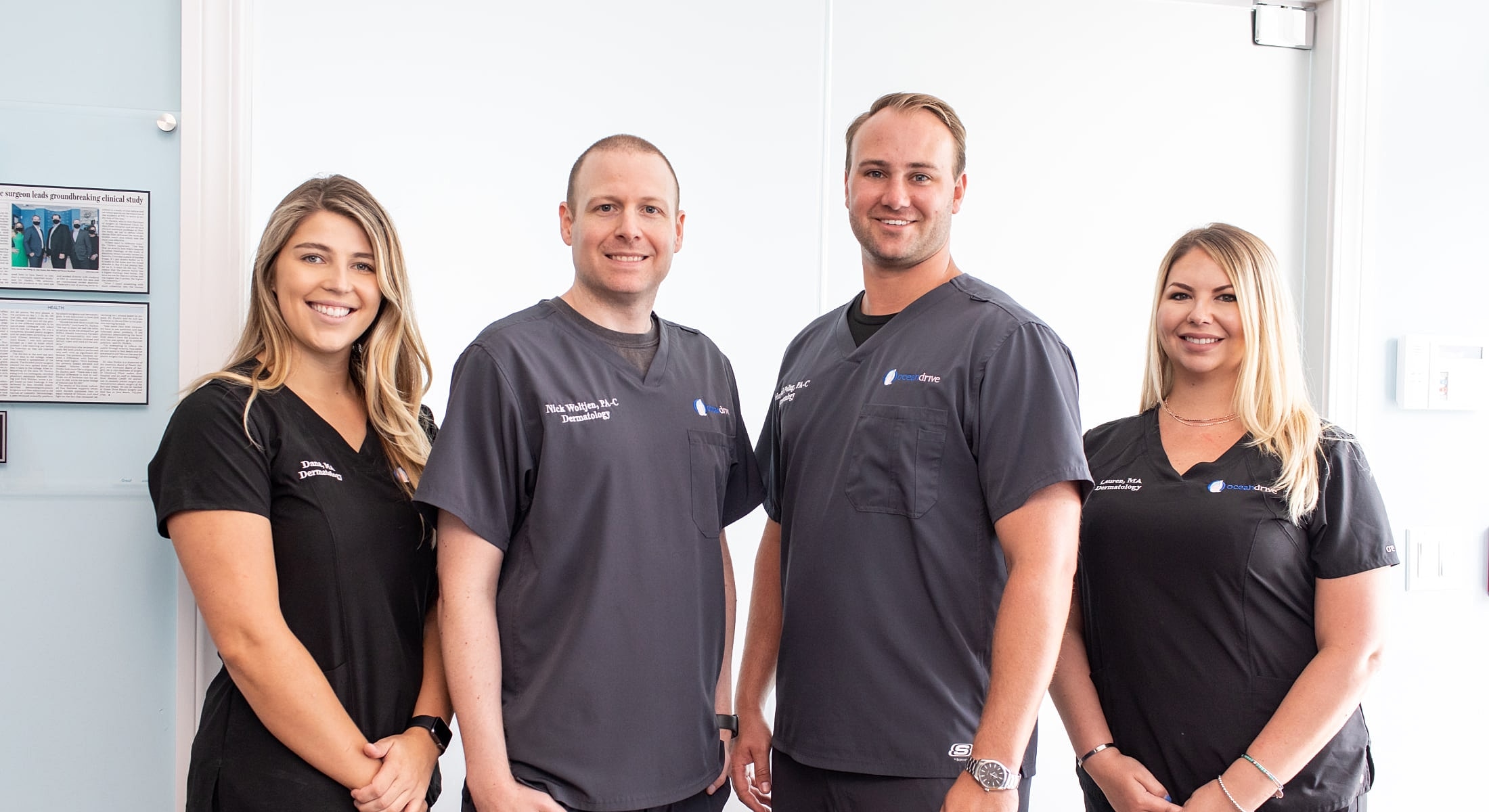 Dermatology team posing together in clinic.