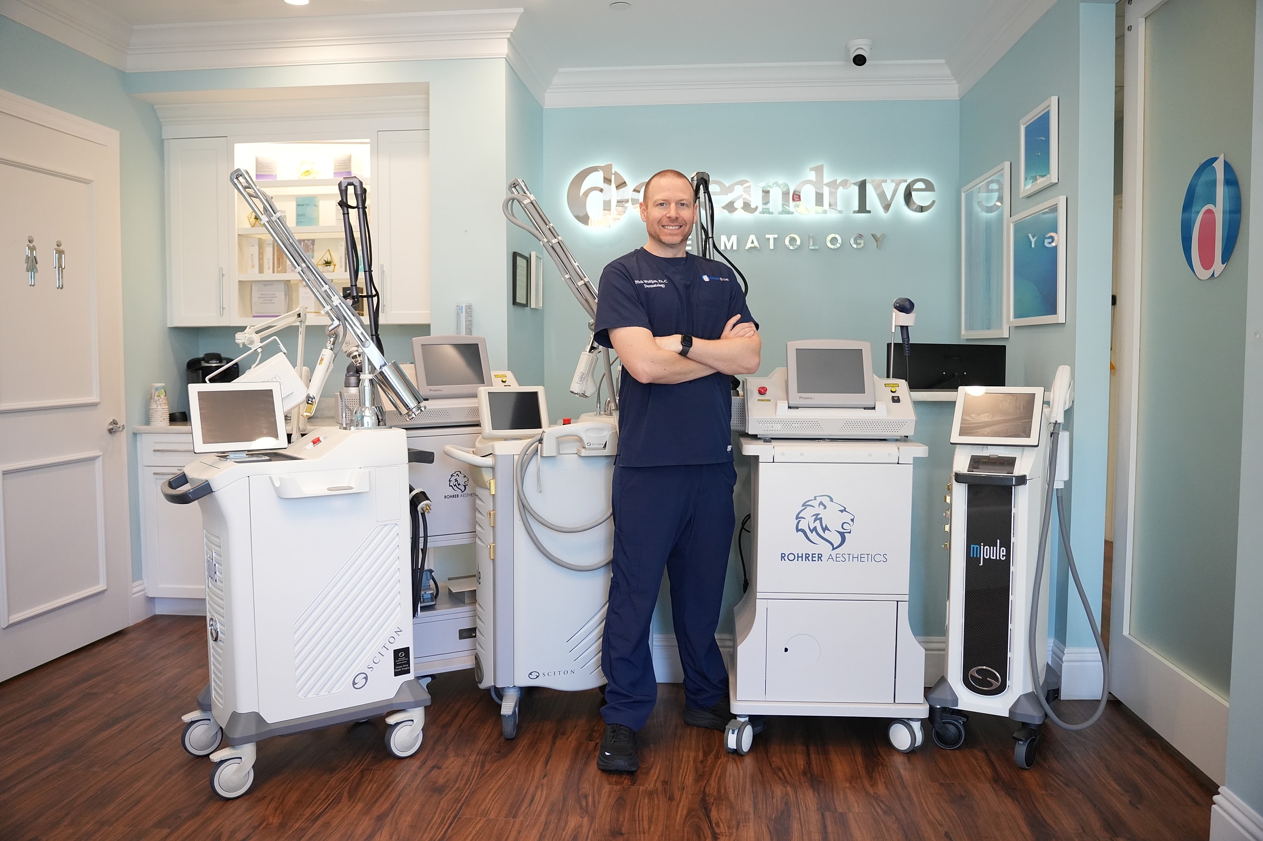 Medical professionals posing in clinic attire.